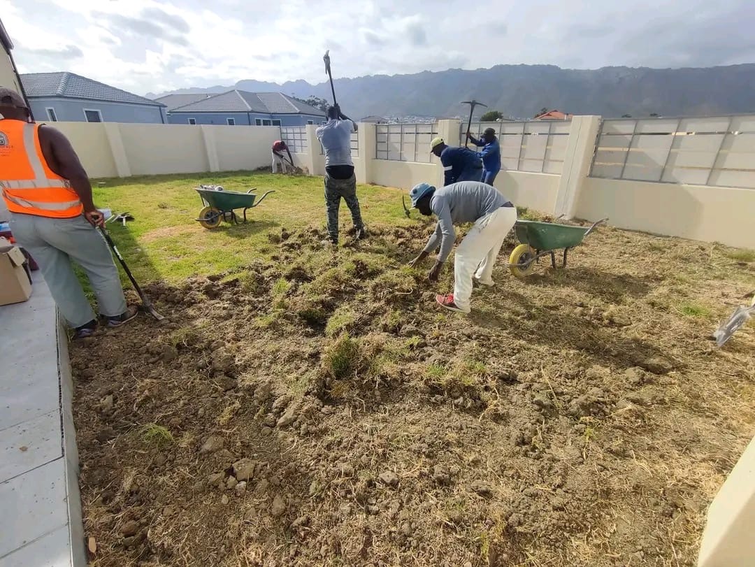 Stellar team clearing and preparing a garden site by hand